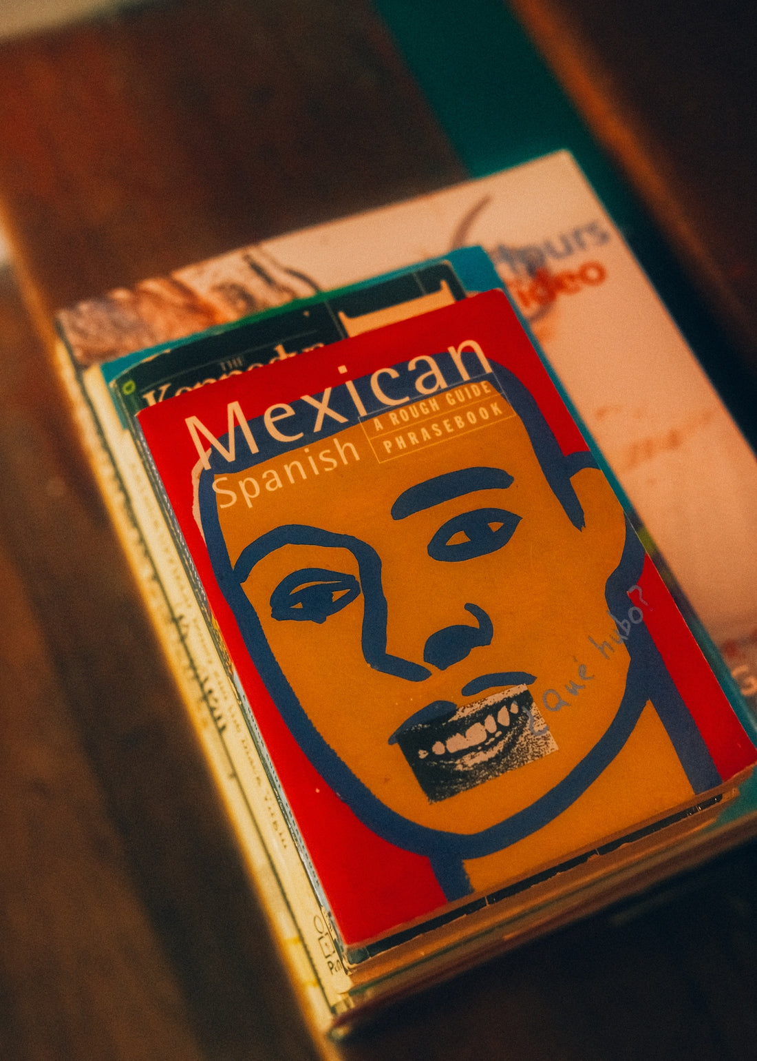 Mexican spanish phrasebook on a stack of books